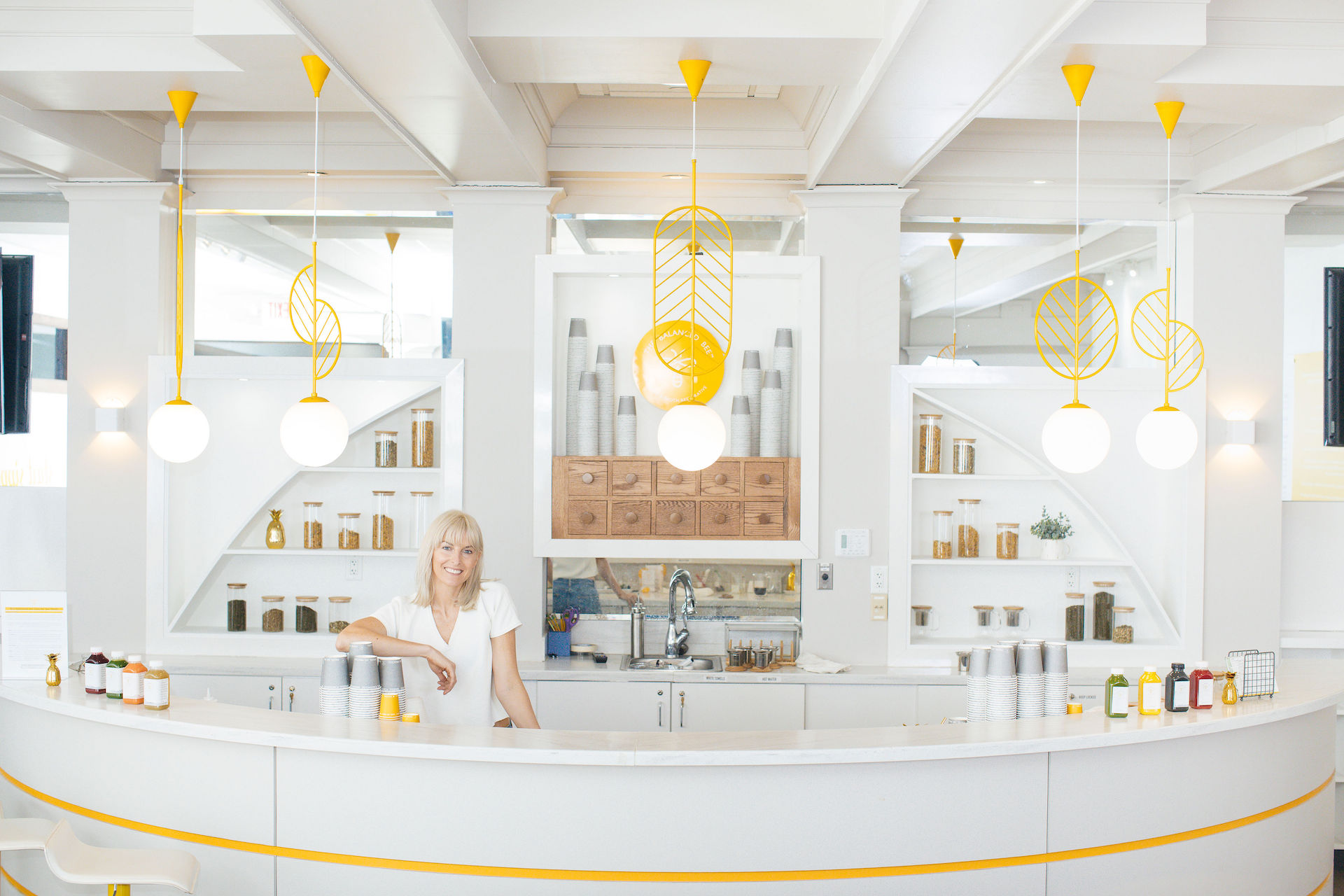 A woman standing in front of a counter.