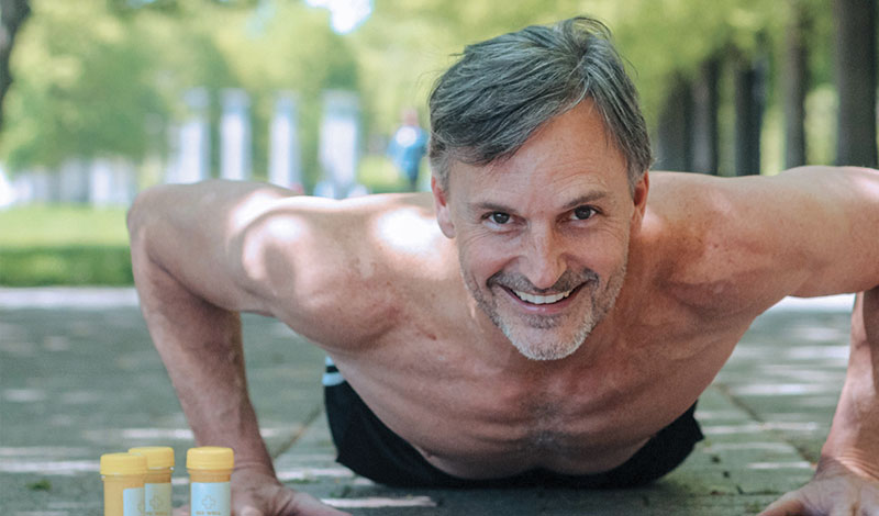 A man is doing push ups on the ground