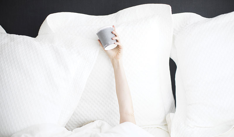 A person is holding a cup in their hand.